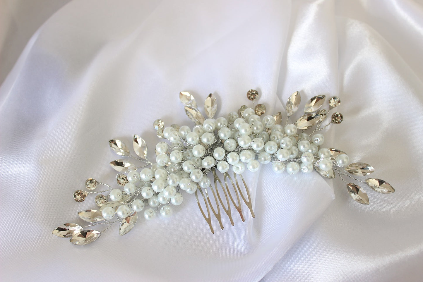 Silver and pearl hair pin on white background