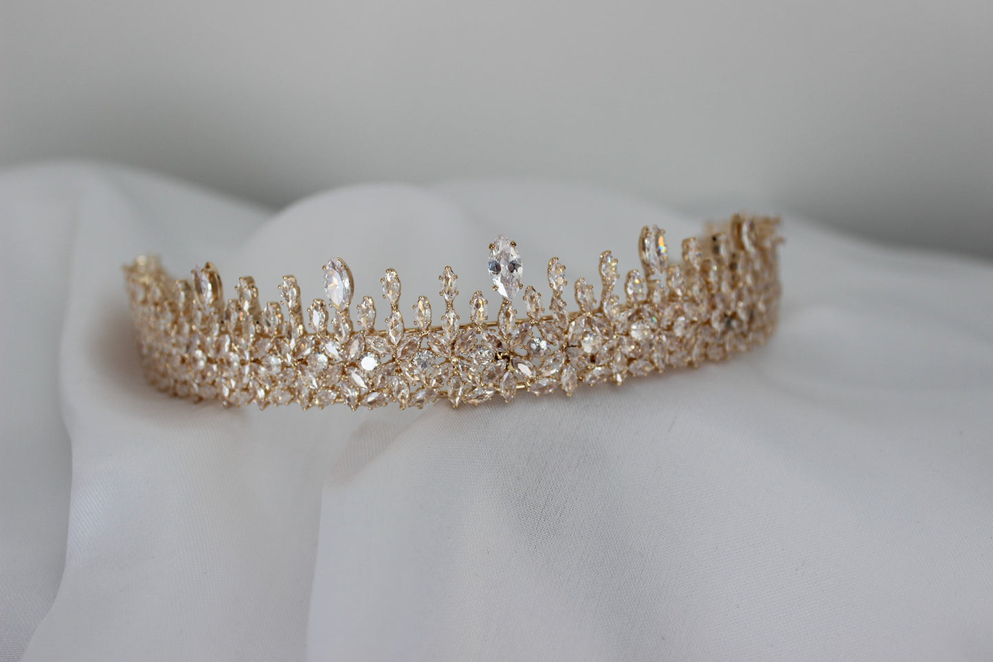 Rose gold bridal crown on white background