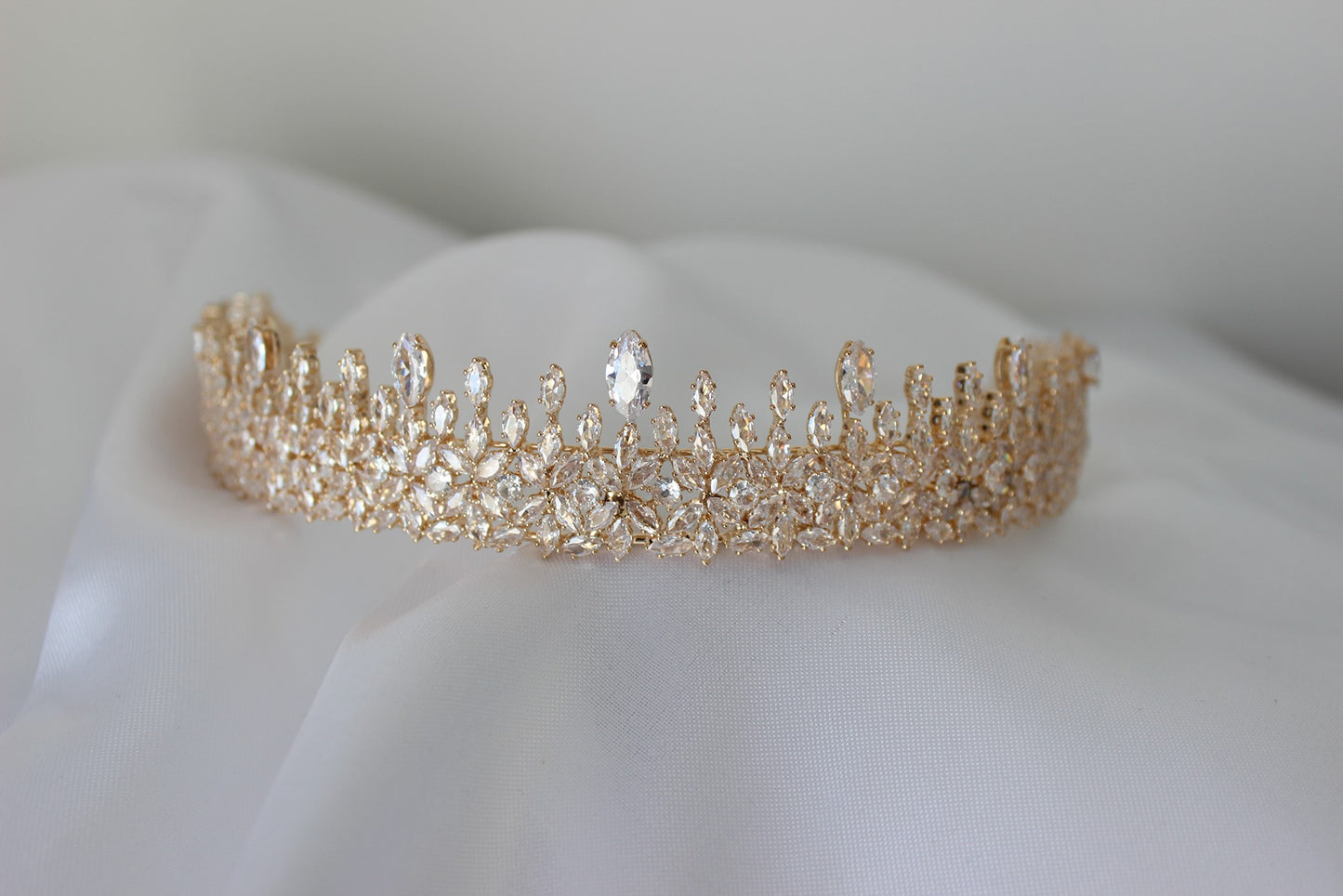 Rose gold bridal crown on white background