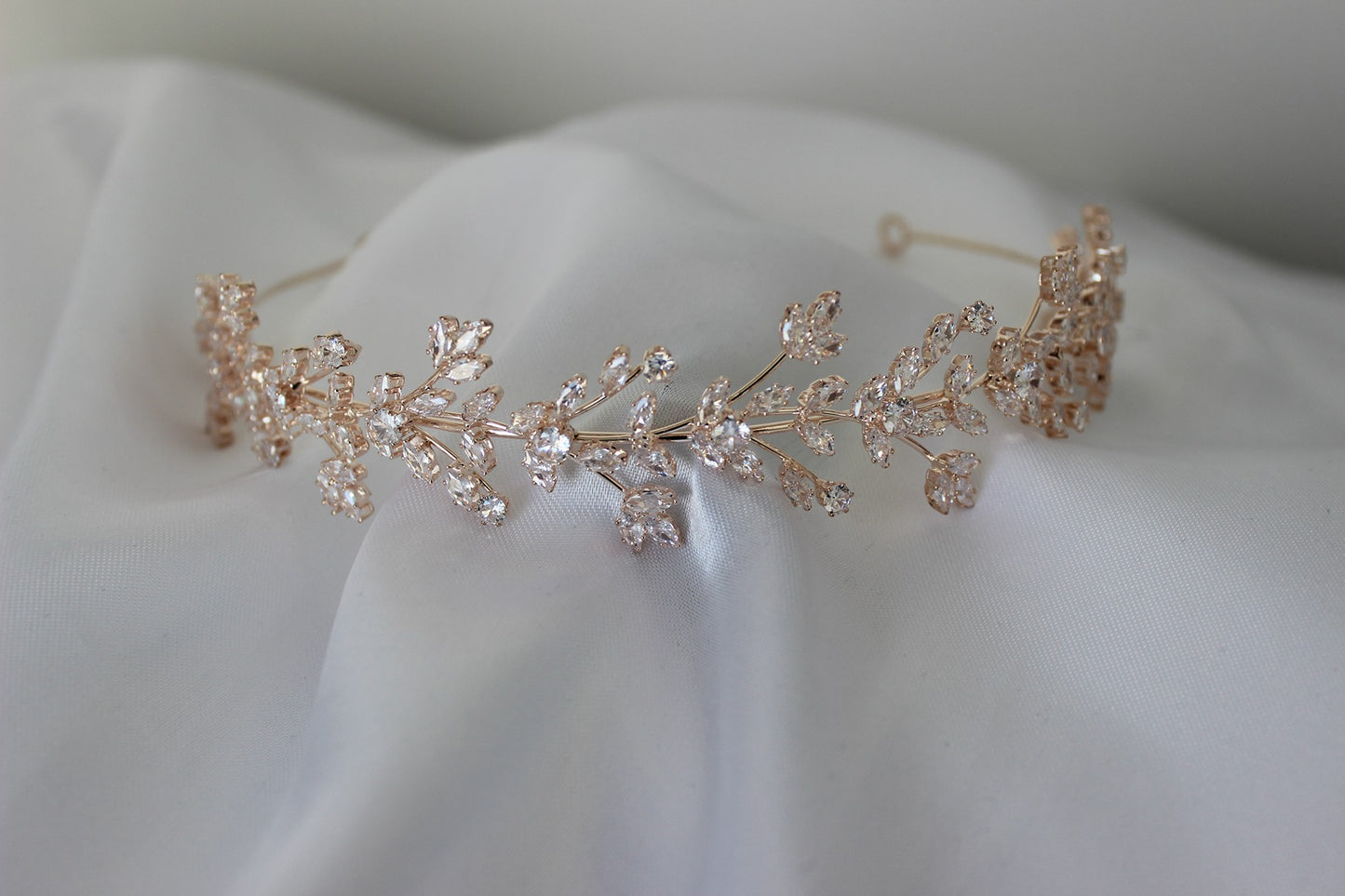 Rose gold bridal headband on white background