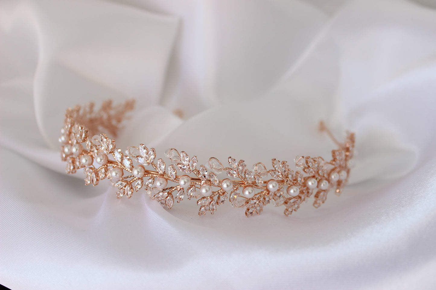 Rose gold bridal headband on white background