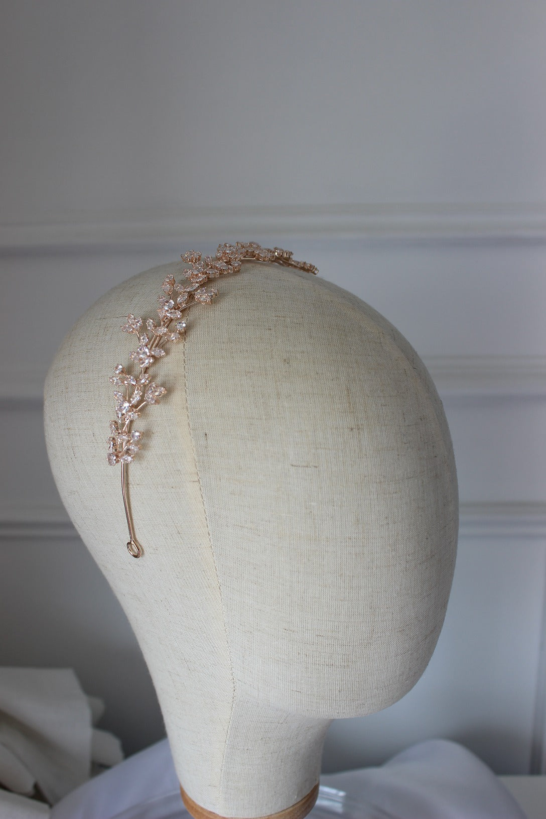 Rose gold bridal headband on mannequin