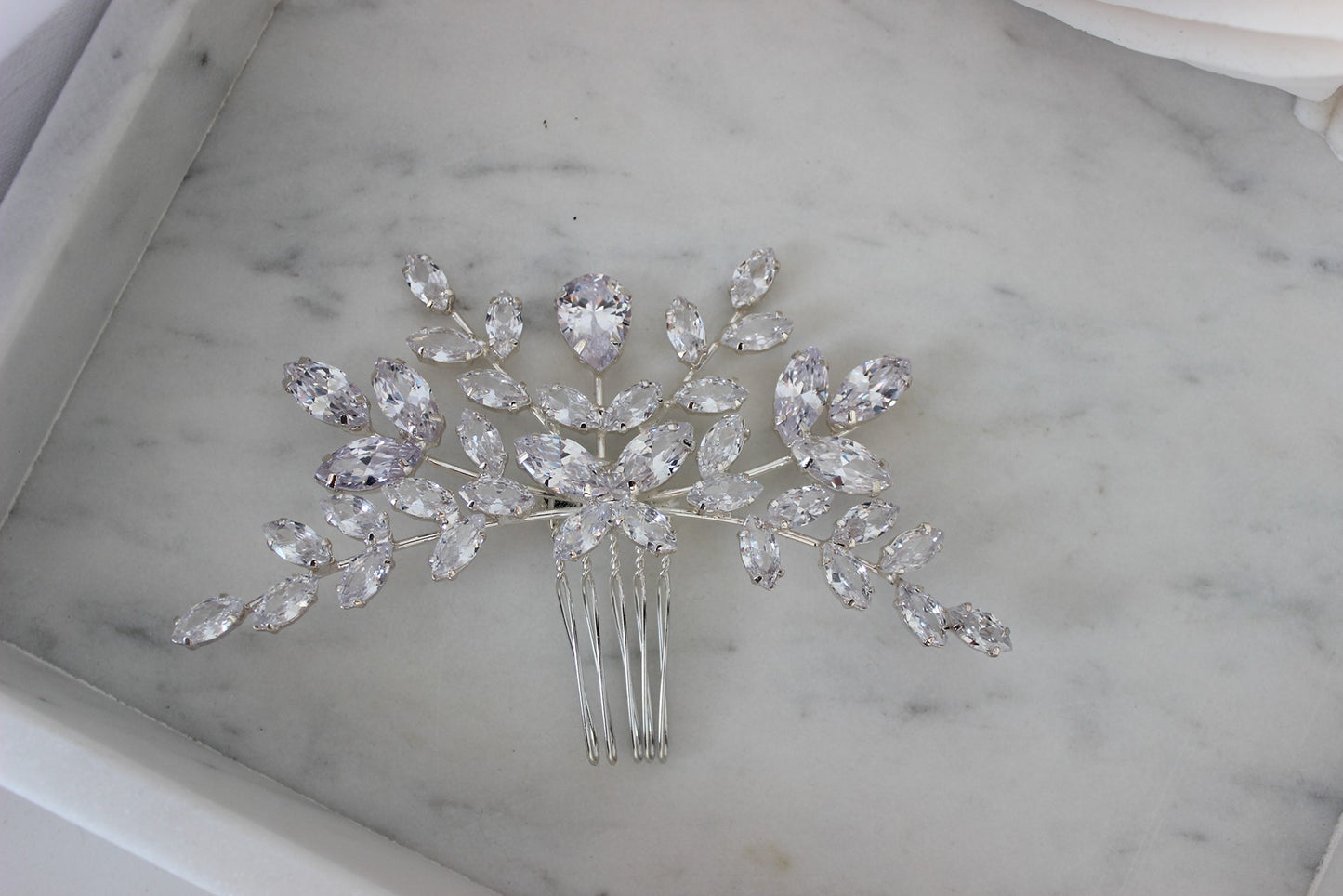 Silver hair pin on white background