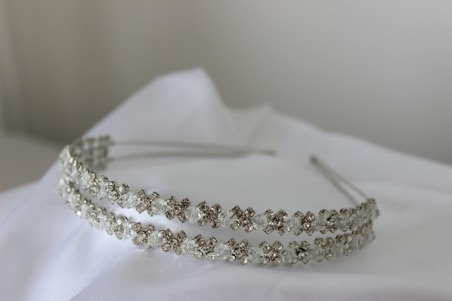 Silver flowergirl headband on white background